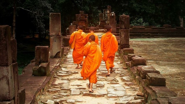 Young Buddhist monastics walking.