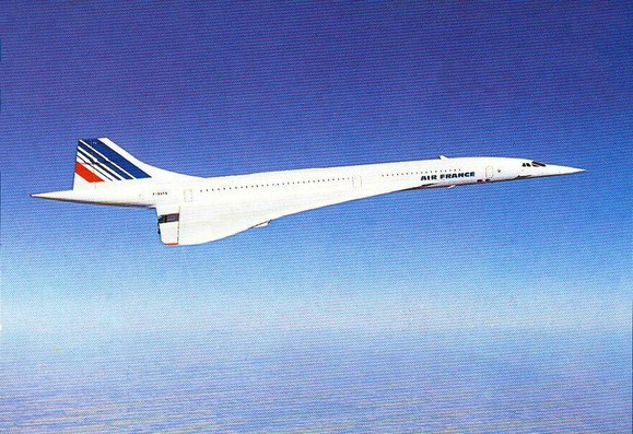 Airplane is seen flying left to right in clear blue skies.