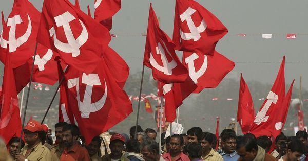 Supporters of the Communist Party of India (Marxist) hold their party flags during a rally. | Jayanta Shaw/Reuters

The flags are red with a large, white hammer and sickle icon at the center.
