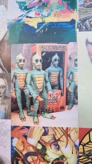 color photo of green humanoid reptiles with green skin, yellow bellies, pointy heads, and big black eyes.