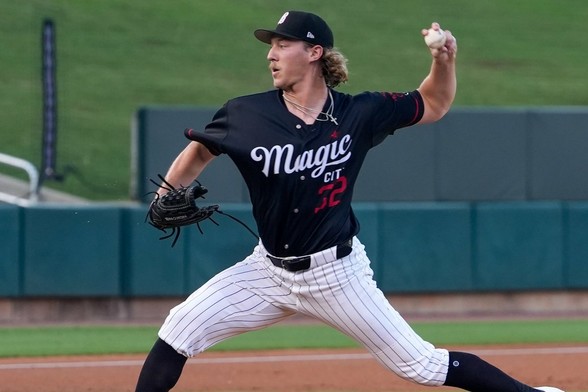 Hagen Smith winds up to throw a pitch while wearing a black uniform top with "Magic City" across the chest in white text.