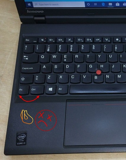 The image shows a part of Lenovo laptop keyboard. The hand-drawn red arrows are pointed towards Fn and Ctr keys. Below there is a hand-drawn "dead" smiley face with Italian hand gesture directed to those keys.