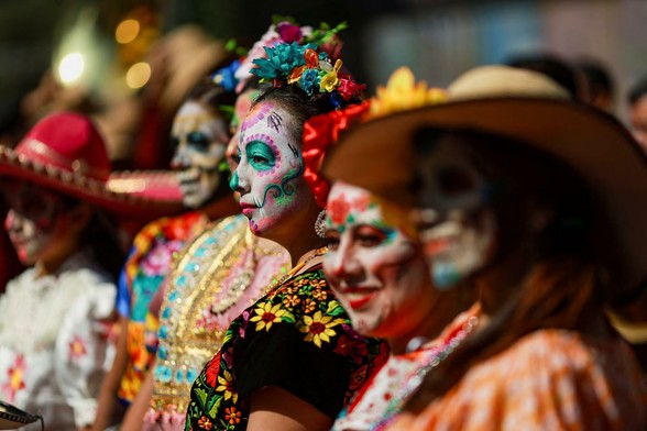 Representatives of Indigenous communities wear masks and traditional costumes from various regions of the country as they parade through the streets.