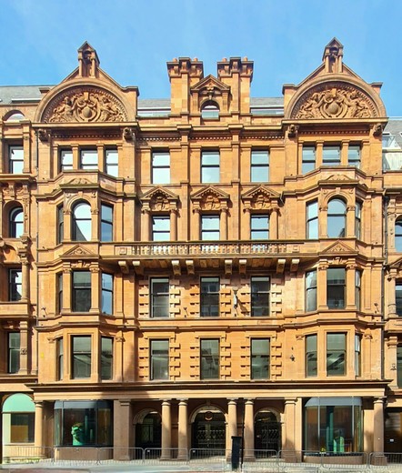 An ornate red sandstone Renaissance style Victorian commercial building.