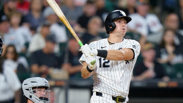 Colson Montgomery follows through on his swing and watches the flight of the ball wearing the Chicago White Sox home uniform