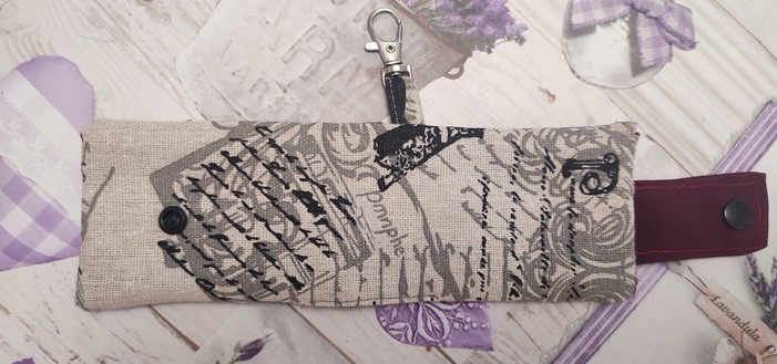 Open Keyring with card-holder handmade. Fabirc is a whitish colour wit the closure that is red and a black snap button.