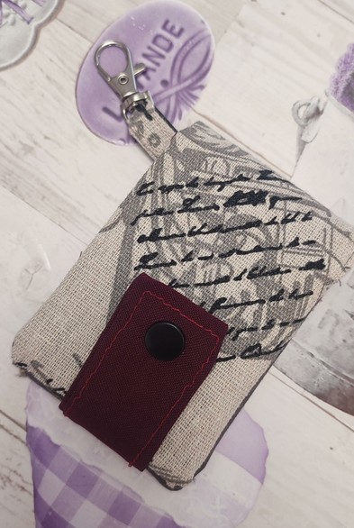 Open Keyring with card-holder handmade. Fabirc is a whitish colour wit the closure that is red and a black snap button.