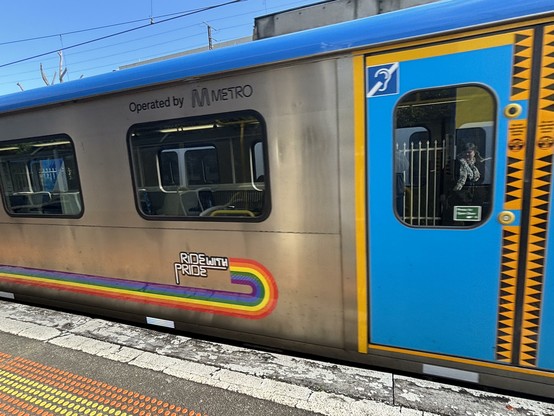 Train carriage with rainbow strip.