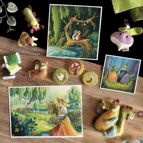 Picture of a collection of illustration and handmade felt items featuring the colour green. Three illustrations set in nature: a big square one with two Egyptian geese cuddling on a log in the middle of a lush river; three magical rocks in a clearing; and a anthropomorphic cockatiel walking among a flowery garden. There are also three button badges; two insect magnets; a duck keychain; a turnip bag charm; and a small crocodile plushie.