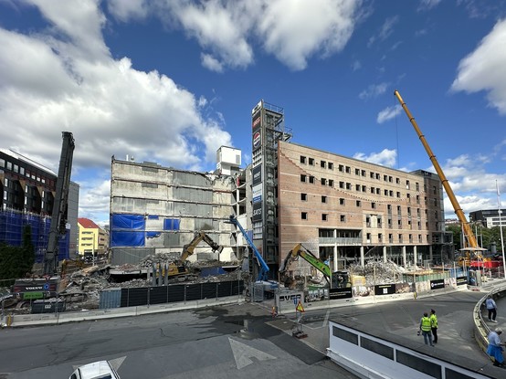 A picture of a partly demolished Oslo Spectrum eventually, being torn down by heavy machinery.