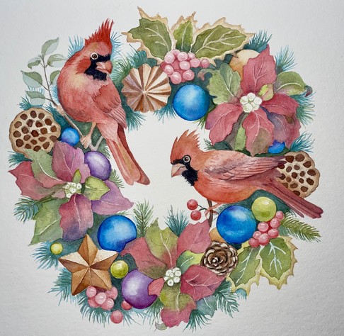 Two crested cardinals are perched within a festive wreath made of leaves, berries, pinecones, seed pods, and round ornaments, creating a lively and decorative circle.