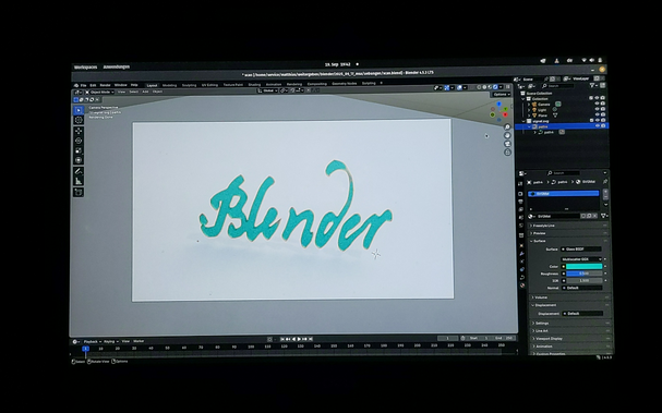 Programmfenster von Blender mit einem türkisfarbenen Kurvenobjekt eines handgeschriebenen Schriftzugs „Blender“
