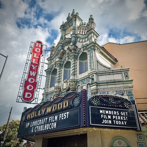 The Hollywood Theatre exterior facade stands tall, as the marquee reads, "HP LOVECRAFT FILM FEST & CTHULHUCON."