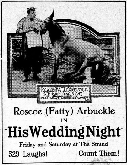Advertisement from a newspaper. Black and white. There is a man standing up outdoors besides a horse. The man is wearing a hat, a long-sleeved shirt, a white apron, black trousers and shoes.