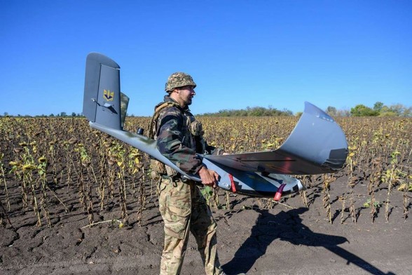 Ukrainian Army drone squad leader Dmytro Sadovets of the 148th Separate Artillery Brigade carries a Ukrainian-made Gor reconnaissance drone for flight over Russian-occupied areas of Donetsk Oblast, to identify Russian military targets, behind the southeast frontline fall 2025, in Novopavlivka direction, Ukraine