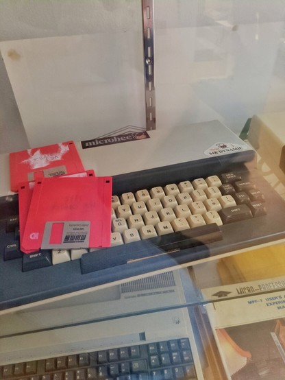 Another MicroBee with some red floppy disks.