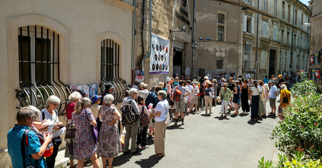 Theatergoers lining up in the afternoon sun to see a play during the Avignon Festival, which is held in summertime in the south of France.