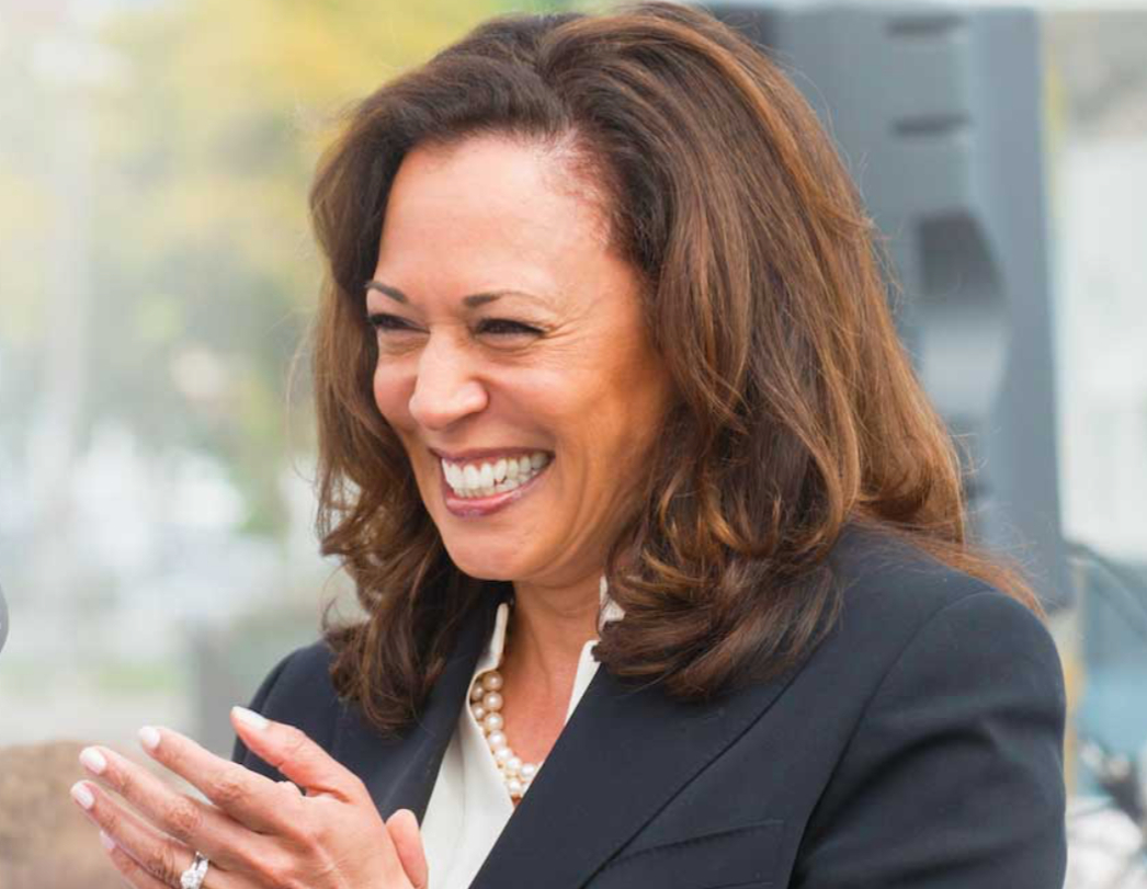Kamala Harris smiling and clapping