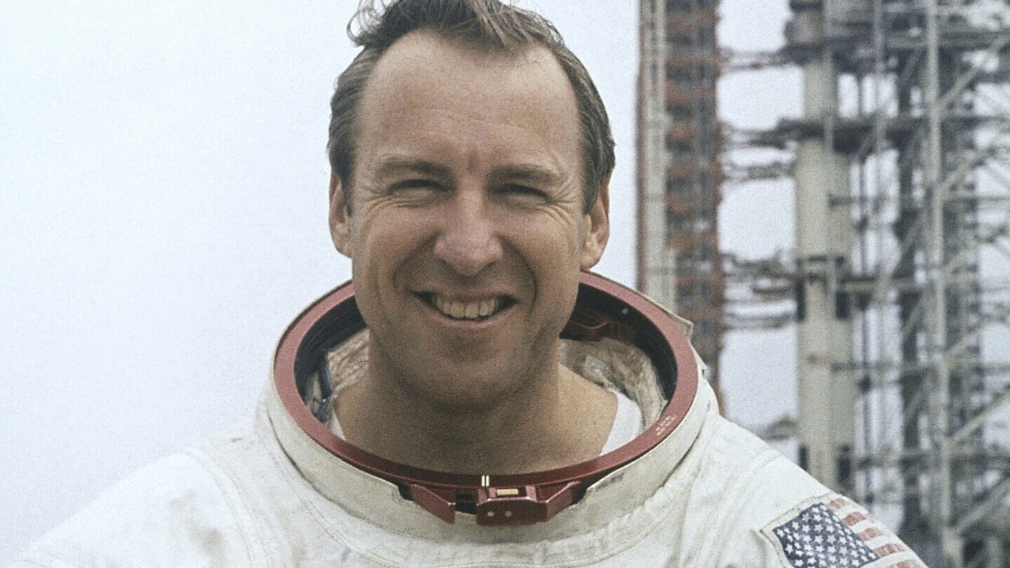 In this photo provided by NASA, astronaut James Lovell, Apollo 13 commander poses for a portrait in his space suit, Feb. 16, 1970. (AP Photo/NASA, File)