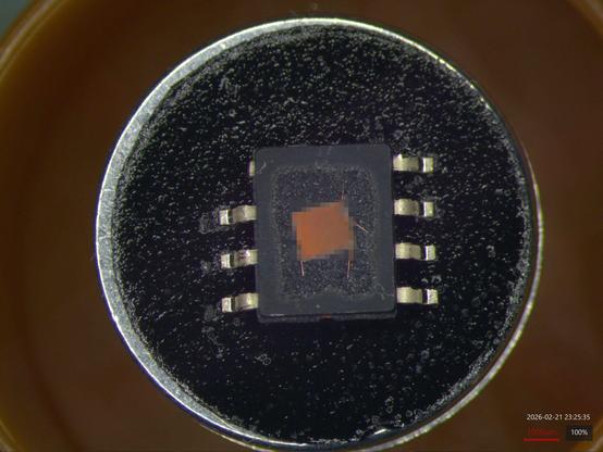 8-pin SOIC on a SEM stub with a nice clean rectangular cutout etched in the middle exposing a die and copper bond wires