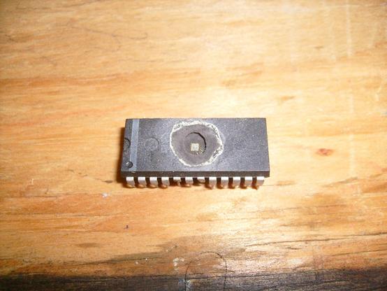 28 pin DIP with a giant crater etched in the middle exposing the die at the bottom of a deep hole