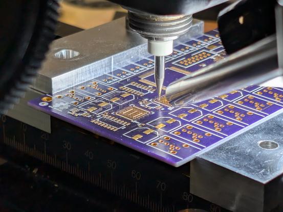 Cheap usb camera in a metal pencil form factor pointed at a pcb