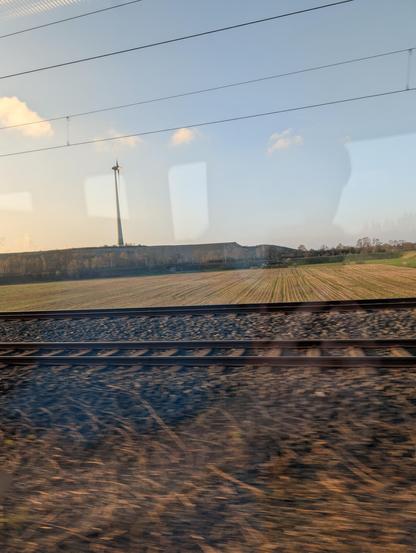 One lone wind turbine seen from a train