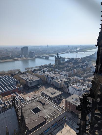 Photo of Köln seen from the top of the cathedral looking towards the Rhine with several bridges in the distance