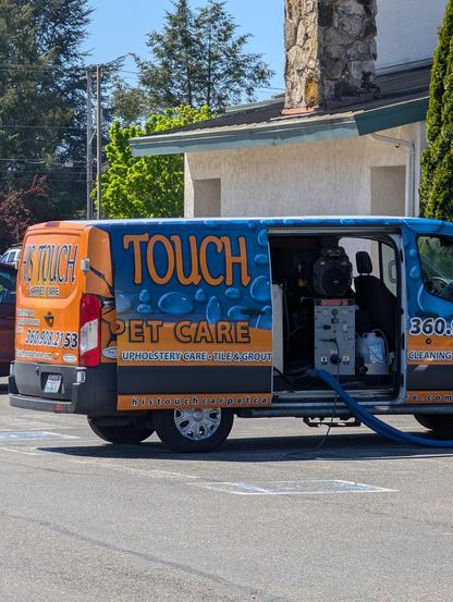 Carpet cleaning van that says "carpet care" on the side but with the door open it just days "pet care"