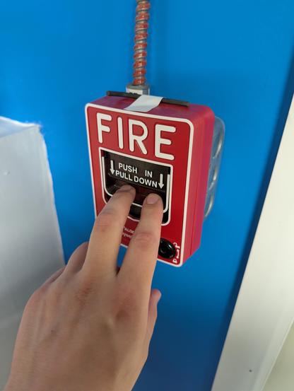 Me about to activate a fire alarm pull station as part of a routine test