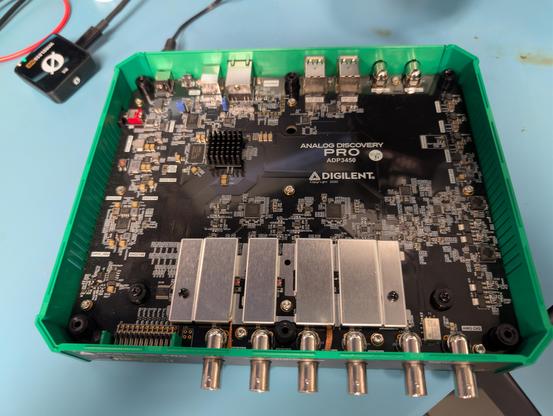 Inside of an ADP3450 showing six front panel BNCs and a bunch of analog stuff under EMI cans