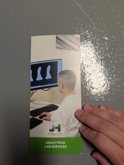 Brochure from JH Analytical showing a SEM operator looking at a bunch of ball bonds in cross section that have a very suggestive shape from this perspective