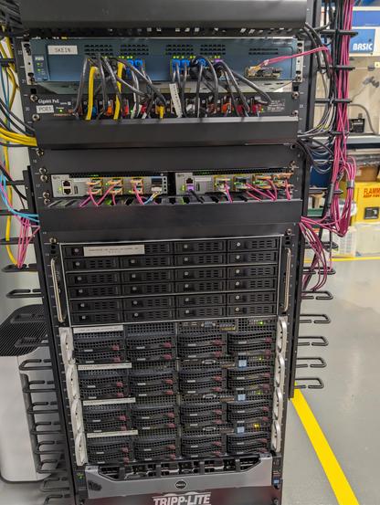 Bottom half of the rack showing fiber coming off the switches