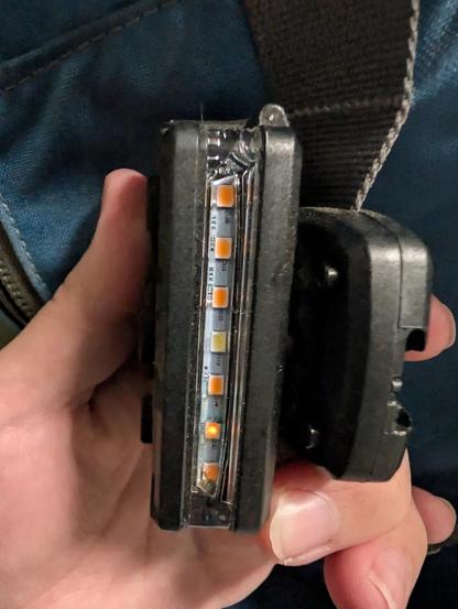 LED strobe on a backpack showing the second diode from the bottom glowing slightly