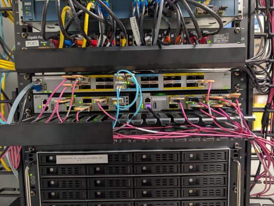 1U QSFP switch on top of two half width switches