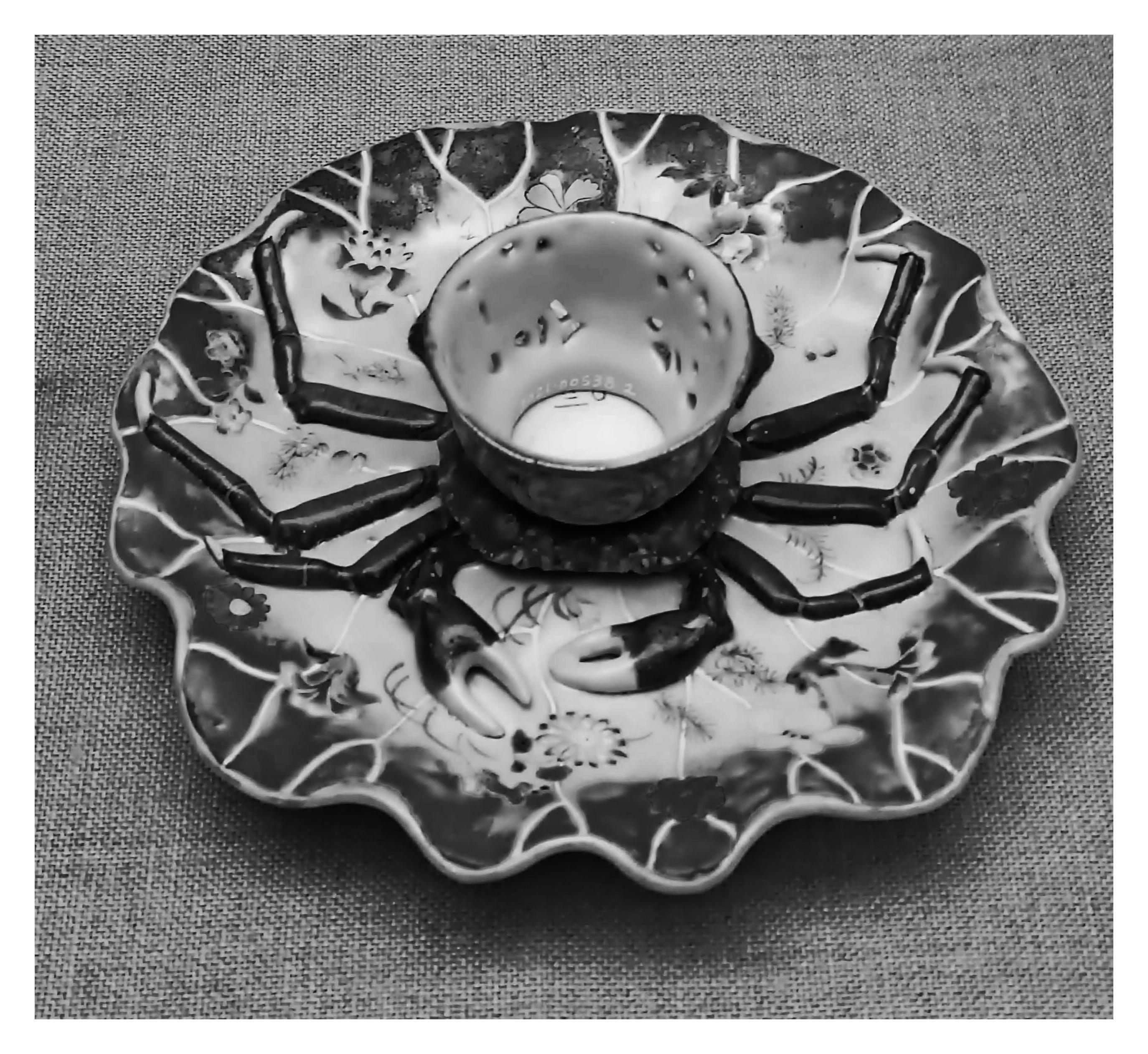 a coffee cup in the shape of a crab.