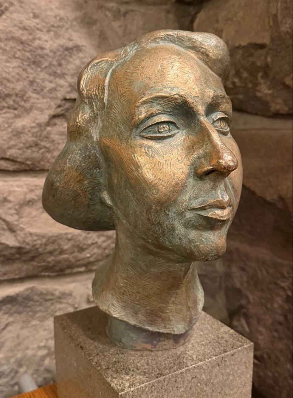 A bronze bust of a woman
