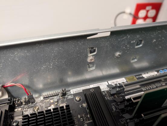 Fastener on side of server chassis with a tiny bit of visible dust