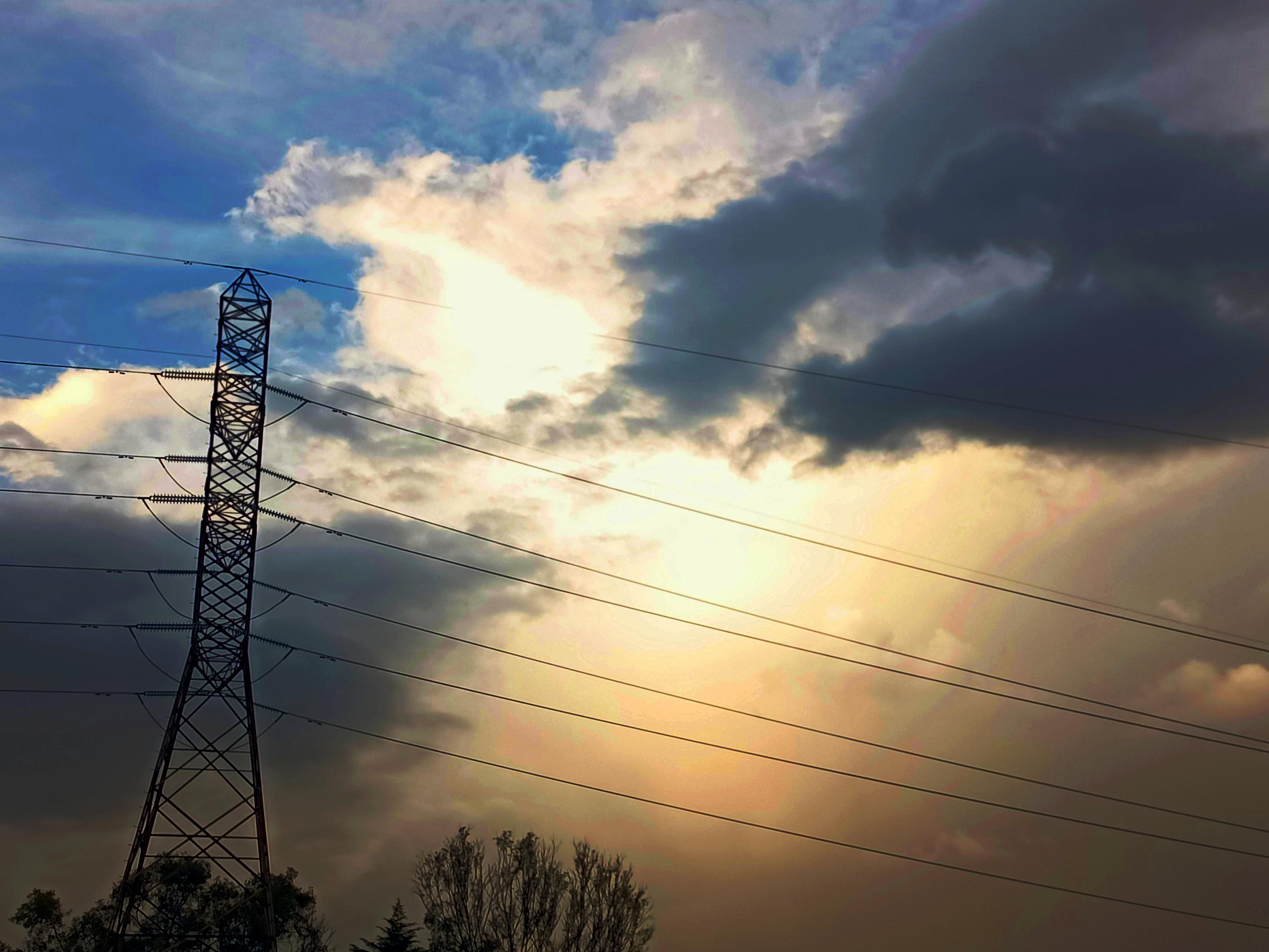 a photo of an electric tower and some afternoon lights in the sky