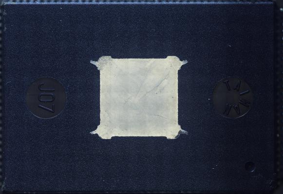 Underside of the package showing ejector pins labeled "J07" and "Taiwan" and a heatsink paddle under the die