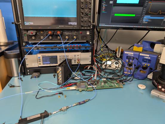 Long shot of the serup showing the Siglent vector signal generator and oscilloscope on the ends of the cables