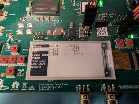 Menu on eink display showing four test points selected output of PRBS7, UART, and I2C SDA/SCL