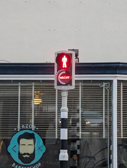 Crosswalk sign with a circular LED graph showing about half the wait time has passed