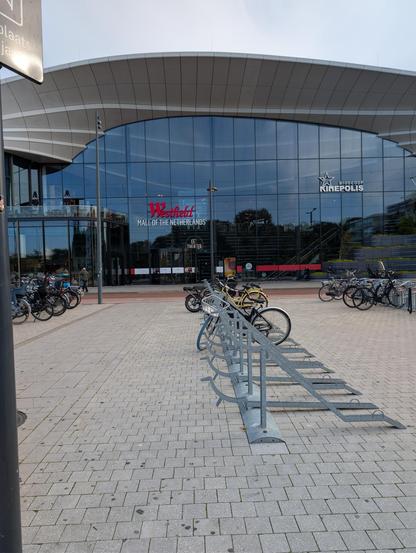 Bicycle parking in front of a large shopping mall entrance