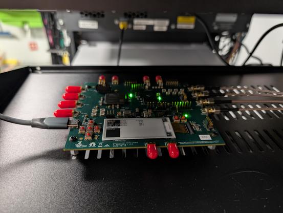 Closeup of a STM32 + FPGA board with four SMA cables coming off the right side