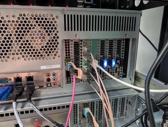 Back of a 4U server showing a 100G NIC, USB3 card, three single slot GPUs, and a ThunderScope with four BNC cables coming off it