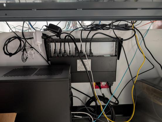 1U PDU wall mounted with slightly less spaghetti cable than before