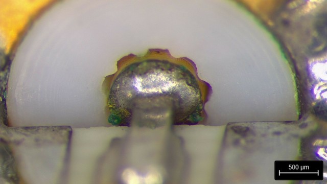 SMA connector with green corrosion visible on the outside of the dielectric, plus two green crystals growing on the center pin