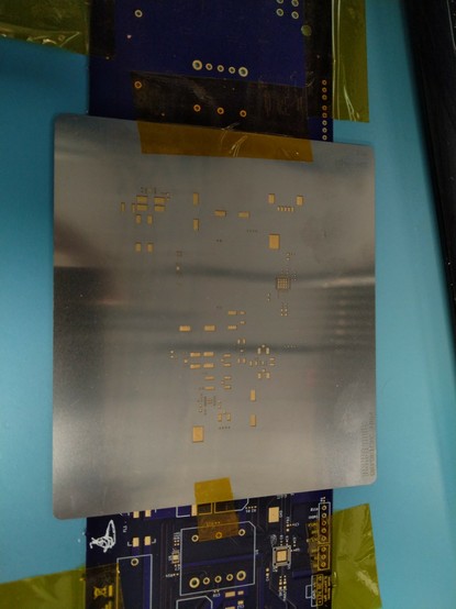 Solder paste stencil positioned over a PCB