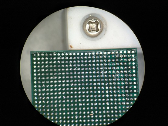 BGA covered in flux with a bunch of missing solder balls